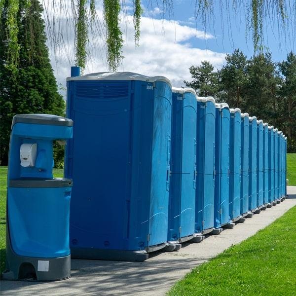 Multiple portable toilets lined up together for delivery